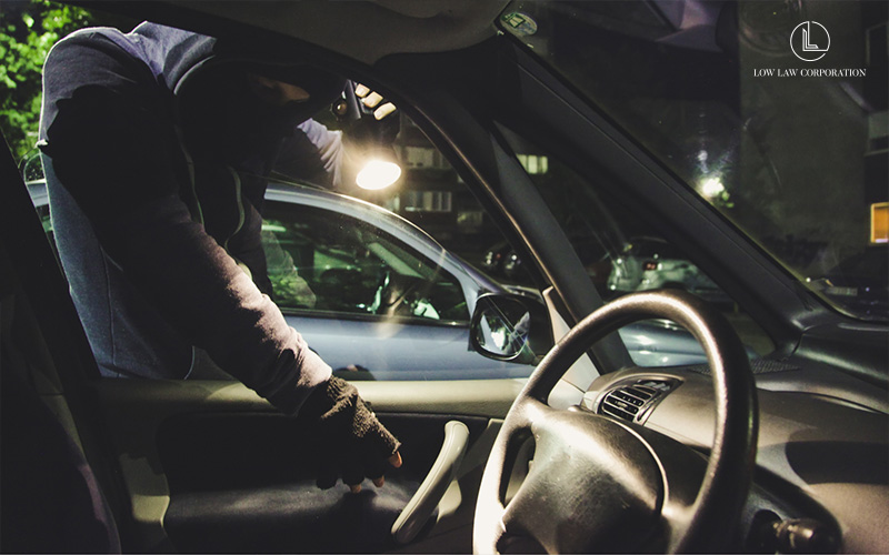 Image of person breaking into a car