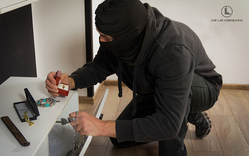 Masked Person stealing jewelry from a home